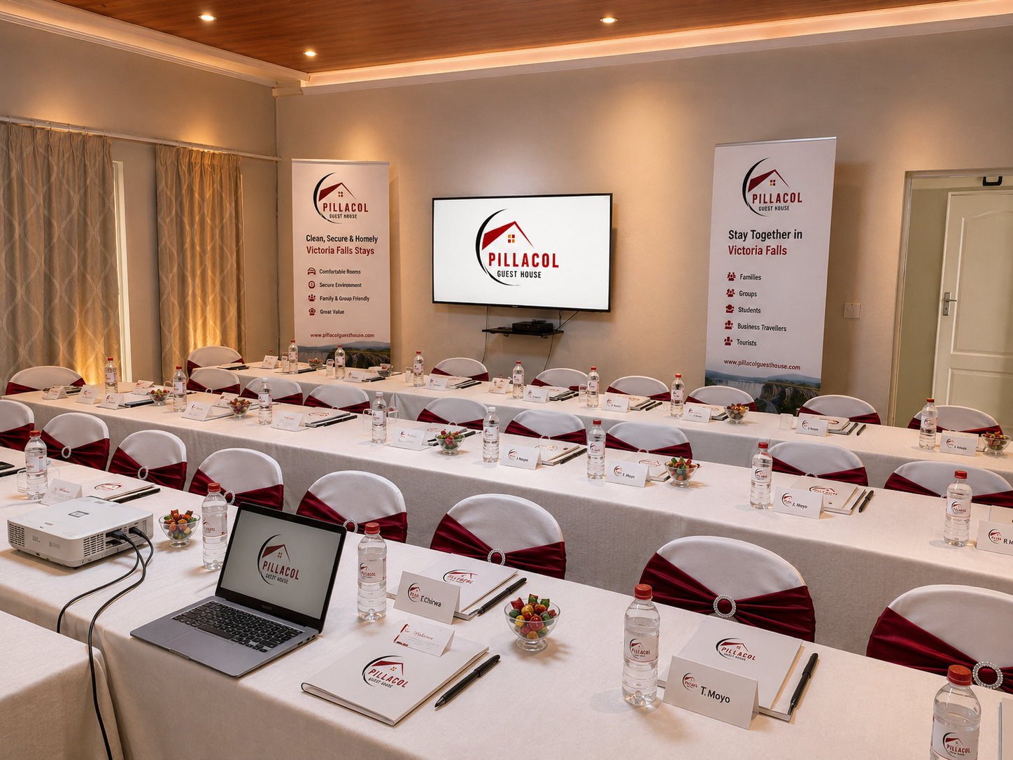 Pillacol Guest House conferencing setup with tables, chairs and branded materials